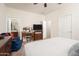 Bright bedroom featuring a TV, dresser, and comfortable seating at 22568 W Gardenia Dr, Buckeye, AZ 85326