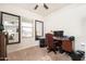 Bright home office with a large desk and comfortable chair at 22568 W Gardenia Dr, Buckeye, AZ 85326