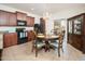 Kitchen with dark wood cabinets, granite counters, and breakfast nook at 22568 W Gardenia Dr, Buckeye, AZ 85326