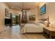 Main bedroom with king bed, fireplace, and backyard access at 25555 N Wrangler Rd, Scottsdale, AZ 85255
