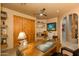 Home office with wood desk and built-in shelves at 25555 N Wrangler Rd, Scottsdale, AZ 85255
