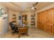 Home office with built-in shelves and wood desk at 25555 N Wrangler Rd, Scottsdale, AZ 85255