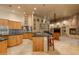 Open concept kitchen with island, stainless steel appliances and views into the living room at 25555 N Wrangler Rd, Scottsdale, AZ 85255