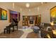 Spacious living room with a fireplace, large windows, and a piano at 25555 N Wrangler Rd, Scottsdale, AZ 85255