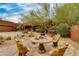Ornate patio furniture sits around a stone table at 25555 N Wrangler Rd, Scottsdale, AZ 85255