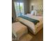 Bright bedroom with a plush bed, ottoman, and window shutters at 25836 N Primo Cir, Rio Verde, AZ 85263