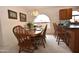 Cozy dining area with wooden table, chairs, and arched window providing natural light at 2625 N 110Th Dr, Avondale, AZ 85392