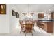 Dining room with a wooden table and chairs, and kitchen access at 2625 N 110Th Dr, Avondale, AZ 85392