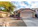Tan house with a two-car garage, and gravel landscaping at 2625 N 110Th Dr, Avondale, AZ 85392