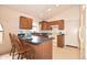 Well-lit kitchen features wood cabinetry, modern appliances, and an arched window at 2625 N 110Th Dr, Avondale, AZ 85392