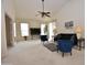 Spacious living room with vaulted ceilings, neutral carpet, and comfortable seating, perfect for relaxation at 2625 N 110Th Dr, Avondale, AZ 85392