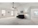 Living room with vaulted ceiling, large windows, and a sofa at 2625 N 110Th Dr, Avondale, AZ 85392