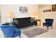 Comfortable living room with contemporary furnishings including sofa, chairs, and a neutral carpet at 2625 N 110Th Dr, Avondale, AZ 85392