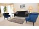 Cozy living room with contemporary furnishings, including plush blue chairs and stylish lighting at 2625 N 110Th Dr, Avondale, AZ 85392