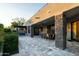 Large covered patio features a dining area and stone pillars at 27448 N 75Th Way, Scottsdale, AZ 85266