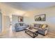 Living room with gray couch, coffee table, and tile floors at 3203 N Sycamore Pl, Chandler, AZ 85224