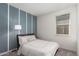 Cozy bedroom with a double bed and blue accent wall at 3244 W Cedar Ridge Rd, Phoenix, AZ 85083