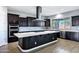 Modern kitchen with dark cabinetry, white countertops, and a herringbone backsplash at 3532 E Penedes Dr, Gilbert, AZ 85298