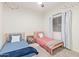 Cozy bedroom with two twin beds and plenty of natural light at 35321 W Santa Monica Ave, Maricopa, AZ 85138