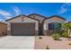 House exterior showcasing a two-car garage and stone accents at 35321 W Santa Monica Ave, Maricopa, AZ 85138