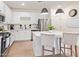 Modern kitchen with white cabinets, stainless steel appliances, and an island at 35321 W Santa Monica Ave, Maricopa, AZ 85138