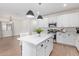 Bright kitchen featuring white cabinets, an island, and stainless steel appliances at 35321 W Santa Monica Ave, Maricopa, AZ 85138