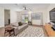 Living room with sliding glass doors, hardwood floors, and a comfy couch at 35321 W Santa Monica Ave, Maricopa, AZ 85138