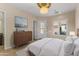 Bright bedroom with access to patio, dresser, and king bed at 36549 N Porta Nuova Rd, Scottsdale, AZ 85262