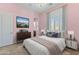 Bedroom with pink walls, queen bed, and stylish decor at 36549 N Porta Nuova Rd, Scottsdale, AZ 85262