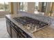 Stainless steel cooktop with granite countertop in a large kitchen at 36549 N Porta Nuova Rd, Scottsdale, AZ 85262