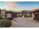 Stunning home exterior at dusk with a three-car garage at 36549 N Porta Nuova Rd, Scottsdale, AZ 85262
