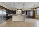 Modern kitchen with dark wood cabinets, stainless steel appliances, and an island at 36549 N Porta Nuova Rd, Scottsdale, AZ 85262
