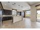 Gourmet kitchen with dark wood cabinetry, stainless steel appliances, and an island at 36549 N Porta Nuova Rd, Scottsdale, AZ 85262