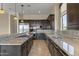 Spacious kitchen with granite countertops, dark wood cabinets, and stainless steel appliances at 36549 N Porta Nuova Rd, Scottsdale, AZ 85262