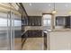 Sleek kitchen features stainless steel refrigerator and dark wood cabinets at 36549 N Porta Nuova Rd, Scottsdale, AZ 85262