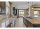 Modern kitchen with granite counters, dark cabinetry, and tile flooring at 36549 N Porta Nuova Rd, Scottsdale, AZ 85262