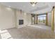 Spacious living room with fireplace and large windows offering scenic views at 36549 N Porta Nuova Rd, Scottsdale, AZ 85262