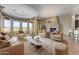 Luxurious living room with plush seating, a fireplace, and large windows at 36549 N Porta Nuova Rd, Scottsdale, AZ 85262