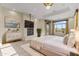 Luxurious main bedroom with a fireplace, large windows, and a TV at 36549 N Porta Nuova Rd, Scottsdale, AZ 85262