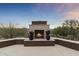 Elegant outdoor fireplace with seating area, perfect for entertaining at 36549 N Porta Nuova Rd, Scottsdale, AZ 85262