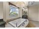 Elegant Primary bathroom featuring a large soaking tub and a view at 36549 N Porta Nuova Rd, Scottsdale, AZ 85262