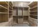 Spacious walk-in closet with custom built-ins and shelving at 36549 N Porta Nuova Rd, Scottsdale, AZ 85262