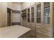 Luxurious walk-in closet with glass-front cabinets and drawers at 36549 N Porta Nuova Rd, Scottsdale, AZ 85262