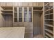 Large walk-in closet with custom built-ins and island at 36549 N Porta Nuova Rd, Scottsdale, AZ 85262