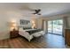 Bright bedroom with wood flooring and sliding door access to patio at 4226 E North Ln, Phoenix, AZ 85028