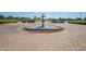 Elegant fountain in a brick paved plaza near tennis courts at 42432 W Abbey Rd, Maricopa, AZ 85138