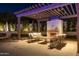 Relaxing patio area with fireplace and comfortable seating under a pergola at 4512 E Exeter Blvd, Phoenix, AZ 85018