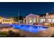 Luxury home with a beautiful pool and expansive backyard at night at 4512 E Exeter Blvd, Phoenix, AZ 85018