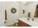 Simple bathroom with single vanity and decorative wreath at 4684 S Maverick Ave, Gilbert, AZ 85297