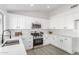 Modern kitchen with white cabinets, stainless steel appliances and quartz countertops at 6516 E Russell St, Mesa, AZ 85215